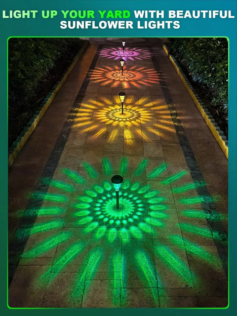 Seven Pack Solar Pathway Lights With RGB Color Changing And A Lit Warm White Glow IP67 Waterproof Outdoor LED Path Lights illuminating a path with colorful sunflower patterns.