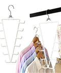 Game Changing Dual Side Closet Hanger With Twelve Rotating Hooks For Organizing Belts Scarves Ties And Gear on clothing rack.