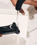 Person rinsing Lawn Mower Five Point Zero Ultra SkinSafe Replacement Foil Blade For Close Body Grooming under running water.
