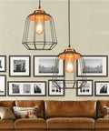 Dimmable Edison LED Bulbs Vintage Style 4W Amber Glass ST64 E26 in pendant lights above a cozy living room with framed art