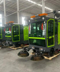 Heavy Duty Commercial Ride On Industrial Sweeper for Warehouses and Factories, green and gray model, efficient floor cleaning machine.