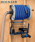 Shop Vacuum Hose Reel With 40 Ft Of 1.5 In Hose Wall Mount Steel Frame Adjustable Tension Knob Easy Install Dust Collector Accessory For Mess Free Cleanup In The Workshop mounted on wood wall with tools.