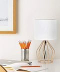 Gold Modern Farmhouse Table Lamps Set Of 2 With Hollowed Out Base And White Fabric Shade on a desk beside a pencil holder