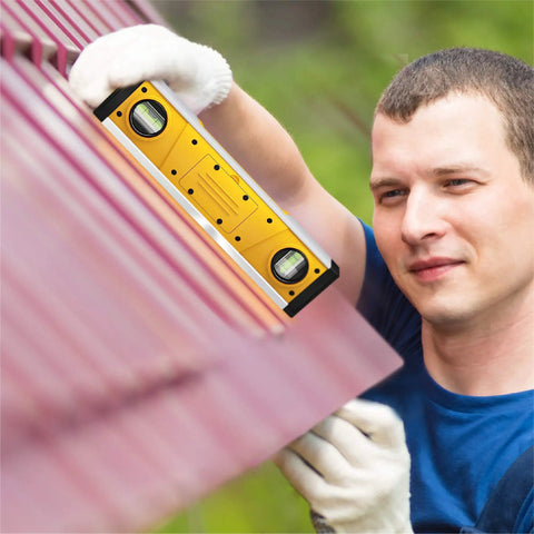 Man using Digital Level 10 Inch Torpedo Level With Protractor And Magnetic Base on roof for outdoor projects