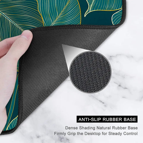 Close-up of Ultra Large Green Tropical Leaves Desk Pad showing anti-slip rubber base texture, ideal for gaming and work setups.