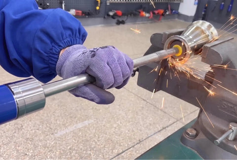 Heavy Duty Pneumatic Air Die Grinder 18000 Rpm With 1/4 Collet in action, grinding metal with sparks flying.