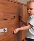 Child interacting with wooden cabinet secured by 3 Inch Keyed Door Lock Hasp Latch In Stainless Steel, heavy duty