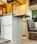 Heavy Weight Aluminum Alloy Telescopic Wall Mount Bracket With Quick Grip Auto Lock, supporting a foldable table in an RV.