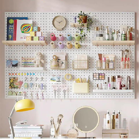Organized pegboard with shelves and baskets holding craft supplies, plants, and books, set on a pink wall