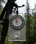 Orienteering Compass With Map Ruler For Hiking And Camping Waterproof Survival Navigation Tool With Clear Dial And Quick Settling Magnetic Needle Transparent Case Hike Ready Outdoor Gear For Backpacking And Scout Use hanging on hiking pole in forest.