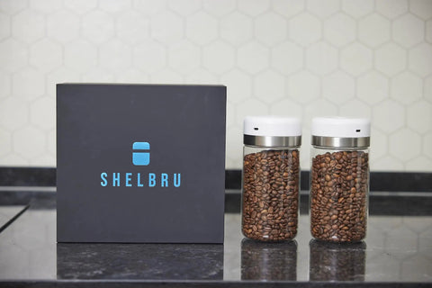 Keep Your Beans Fresh As A Daisy With This Smart Electric Vacuum Seal Coffee Canister And Airtight Storage Jar For Whole Ground Roasts Real Deal Smooth Push Button Operation Durable Borosilicate Glass with two jars and a black box.
