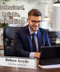 Office setup with Acrylic Desk Name Plate Holder For Office 2x8 Inch Double Sided shows 'General Manager' with man working on laptop