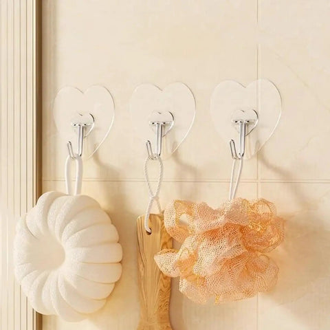 Heavy Duty Adhesive Wall Hooks With Slick Grip keep towels and loofahs organized in a bathroom with a transparent design.