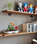 Rock Solid Hidden Floating Shelf Brackets Heavy Duty Black Metal L Bracket supporting wooden shelves with decor items.