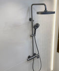Exposed Shower System with Waterfall Tub Spout G1/2 Connection Gun Gray, featuring a round top spray and handheld showerhead.