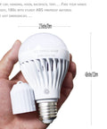 Hand holding Go To Rechargeable LED Light Bulbs With Remote Control Cordless Warm White Emergency Lamp For Home Power Outages 7W