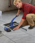 A person using the 24 Inch Manual Tile Cutter With Tungsten Alloy Wheel and Double Rail Track for precision cuts.