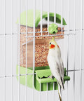 No Fuss Acrylic Automatic Bird Feeder With Sturdy Perch For Cage with a cockatiel feeding inside a green cage.