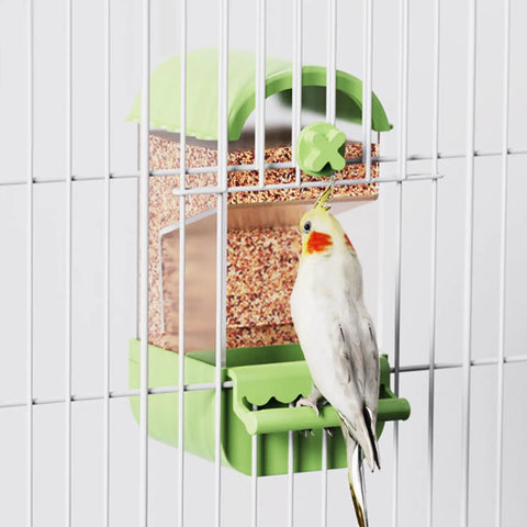 No Fuss Acrylic Automatic Bird Feeder With Sturdy Perch For Cage with a cockatiel feeding inside a green cage.