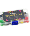 Clear plastic box containing 12x12x7.3mm Tactile Push Button Momentary SMD PCB Switches with color caps, pack of 25 for Arduino projects