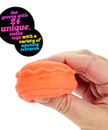 Squishmas Advent Calendar With 24 Days Of Hype NeeDoh Sensory Squishies, orange squishy macaron toy held in hand.