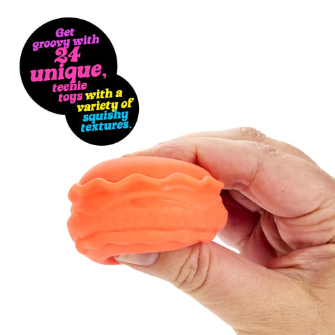 Squishmas Advent Calendar With 24 Days Of Hype NeeDoh Sensory Squishies, orange squishy macaron toy held in hand.
