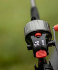 Close-up of a black and red spincast reel mounted on a fishing rod, labeled "Ugly Stik" and "SC20".