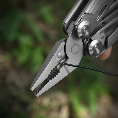 Close-up of Everyday Carry Ready Eighteen In One Stainless Steel Multitool pliers cutting wire outdoors.