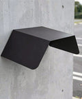 Heavy Duty Aluminum Wall Mount EV Charging Station Rain Shield Weatherproof Canopy mounted on a concrete wall.