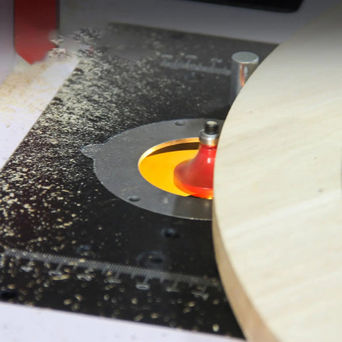 Rock Solid Router Lifting System With Slick Crank Adjustment, sturdy router mounted in a table with wood shavings scattered.
