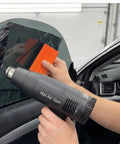 All-In-One Vinyl Wrap Heat Gun Kit For Cars And Window Tinting, 1800W 110V Hot Air Tool With Squeegees in use on car window