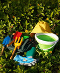 Kids Metal Garden Tool Set For Little Green Thumbs With Real Shovel Rake Fork Trowel Sun Hat Apron Gloves Tote Bag Sprayer and Bucket Educational Outdoor Garden Gift displayed outdoors