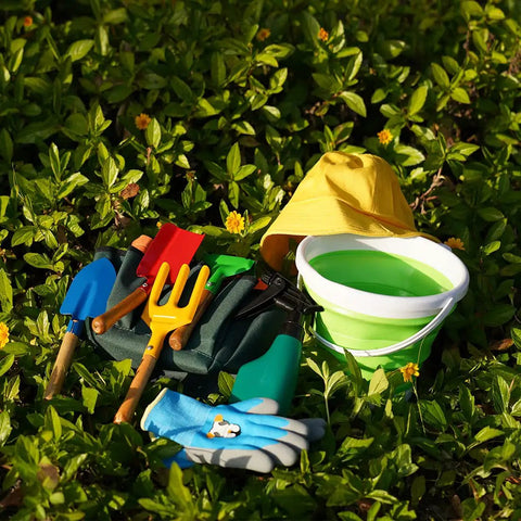 Kids Metal Garden Tool Set For Little Green Thumbs With Real Shovel Rake Fork Trowel Sun Hat Apron Gloves Tote Bag Sprayer and Bucket Educational Outdoor Garden Gift displayed outdoors