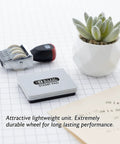Hassle Free Rotating Date Stamp With Separate Black Ink Pad For Filing Invoices And Papers 12 Year Band Range displayed with stamp pad and potted plant.