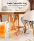 700W Oil Filled Radiator Heater With Adjustable Thermostat Two Heat Settings Overheat Protection Silent Operation Cozy Warmth Under Desk Space Heater For Bedroom And Office White Finish under a desk with a person working