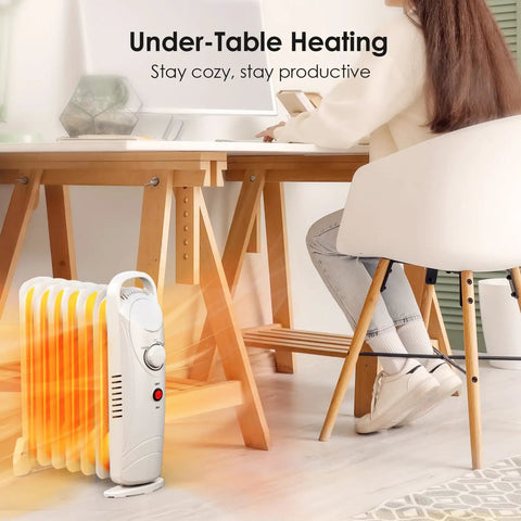 700W Oil Filled Radiator Heater With Adjustable Thermostat Two Heat Settings Overheat Protection Silent Operation Cozy Warmth Under Desk Space Heater For Bedroom And Office White Finish under a desk with a person working