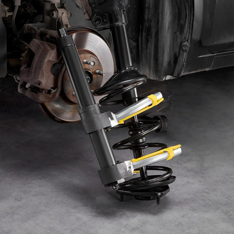 Strut Spring Compressor Kit For MacPherson And Conical Springs with forks attached to car suspension system in garage.