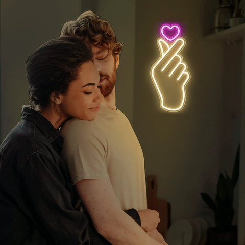 Finger Heart Neon Sign In Pink And Warm White For Bedroom And Game Room LED Light Hand Gesture Decor For K Drama And K Pop Fans Wall Decor Gift For Fans Vibe, with couple enjoying ambiance