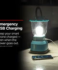 LED Camping Lantern With USB Charging, 800 Lumens Of Bright Light, Battery Powered And 200 Hour Run Time on table with phone charging