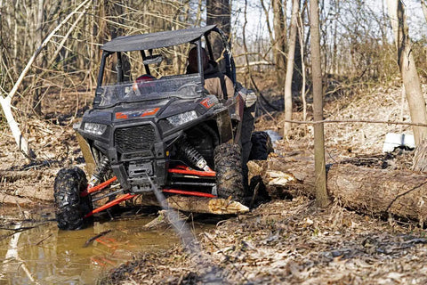 Polaris RZR XP 1000 with Heavy Duty Winch Mounting Plate For Polaris RZR XP 1000 2014 Through 2022 Black Steel Construction Built For Off Road Recovery Easy Install Rock Solid Durability For Mud Trails And Rocks on rough forest terrain.