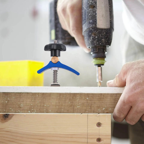 Pro Grade Woodworking T Slot Clamp With Hold Down Function Blue T Track Clip securing wood during drilling in workshop