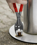 10 Inch Pliers With Front And Side Grips For Stripped Screws And Bolts gripping a rusty bolt on metal surface