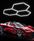 Hexagon LED Garage Lights 16 Pack 128W Ultra Bright 12800LM 6500K Ceiling Shop Light illuminating a red sports car