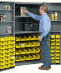 User organizing tools in Heavy Duty Steel Garage Cabinet With Three Adjustable Shelves And 72 Bright Yellow Parts Bins.
