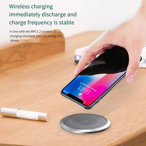 Slick Auto Rising Desk Power Strip With Fast Wireless Charger Tempered Glass Top charging smartphone on a wireless pad.