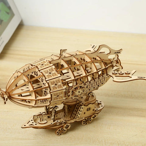 Epic 3D Wooden Airship Puzzle Kit For Adults on wooden table, handcrafted ship model in natural wood finish.