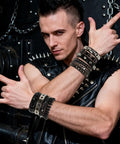 Man wearing Dope Eight Piece Punk Rock Studded Leather Bracelet Set With Adjustable Spiked Zinc Cuffs, showcasing 80s concert vibe.