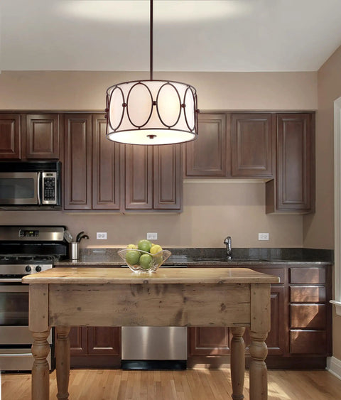 Gold 3 Light LED Pendant Light With White Linen Drum Shade Modern Hanging Chandelier For Dining Room And Kitchen Island 19 Inch Adjustable Metal Ceiling Fixture Energy Saving Lighting illuminates a rustic kitchen.