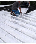 Two workers applying Grizzled Crew Approved Roof Patch Tape With Thick Bitumen Base And Cool Reflective Foil on a roof.