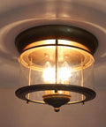 Rustic Gold 3-Light Flush Mount Ceiling Light With Clear Glass Shade, Antiqued Brass Finish, Vintage Style Fixture Illuminated